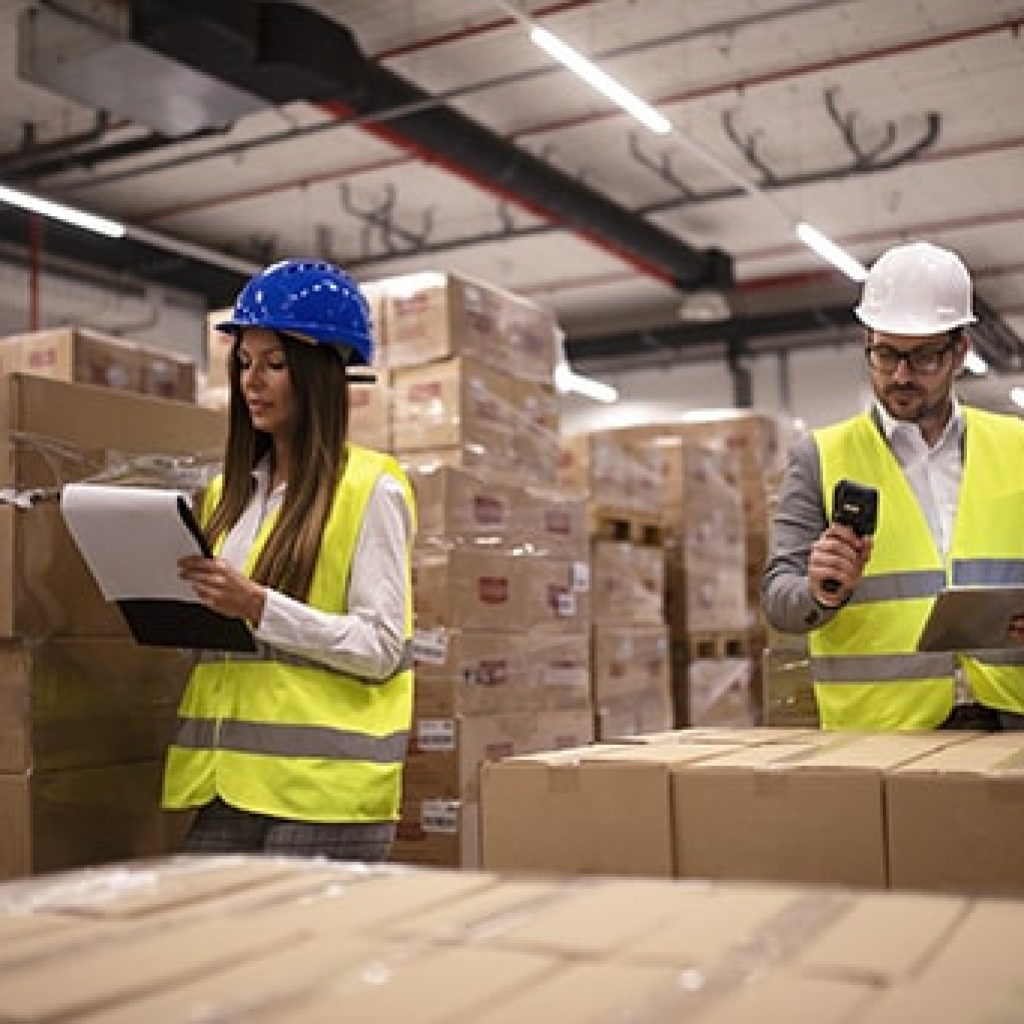 warehouse-workers-using-bar-code-scanner-tablet-checking-goods-inventory-min